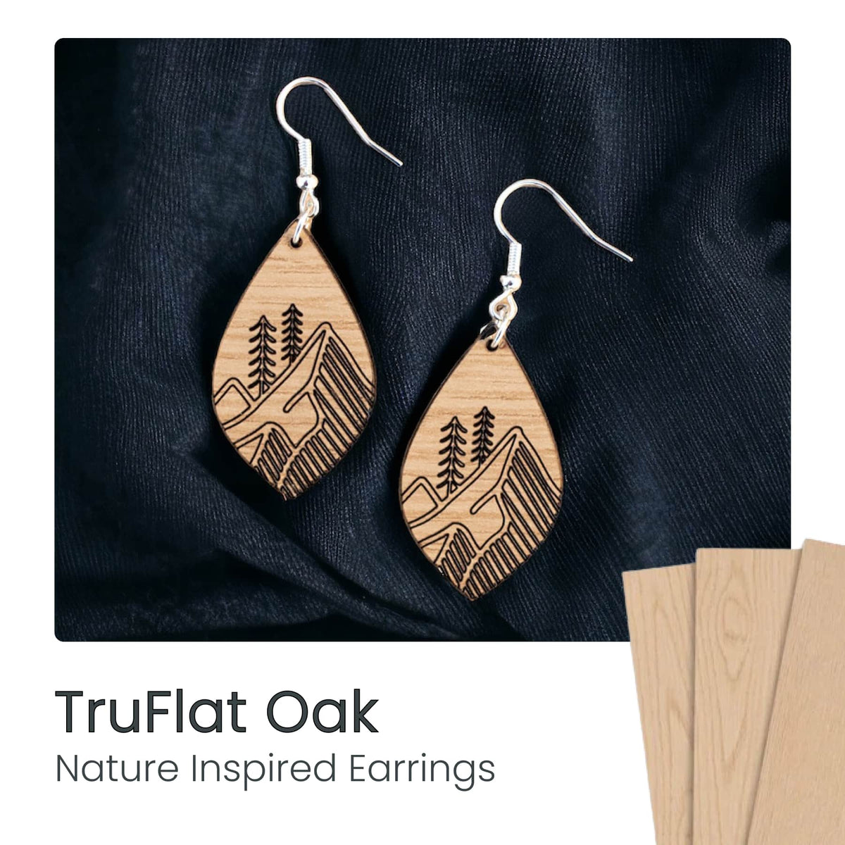 Laser-cut wood dangle earrings with mountain and pine tree pattern