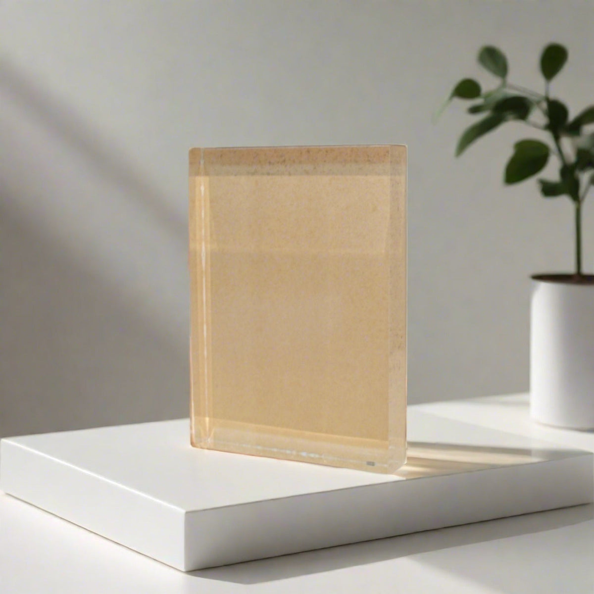 Transparent 3/4 in acrylic face-mount block on a white display base.