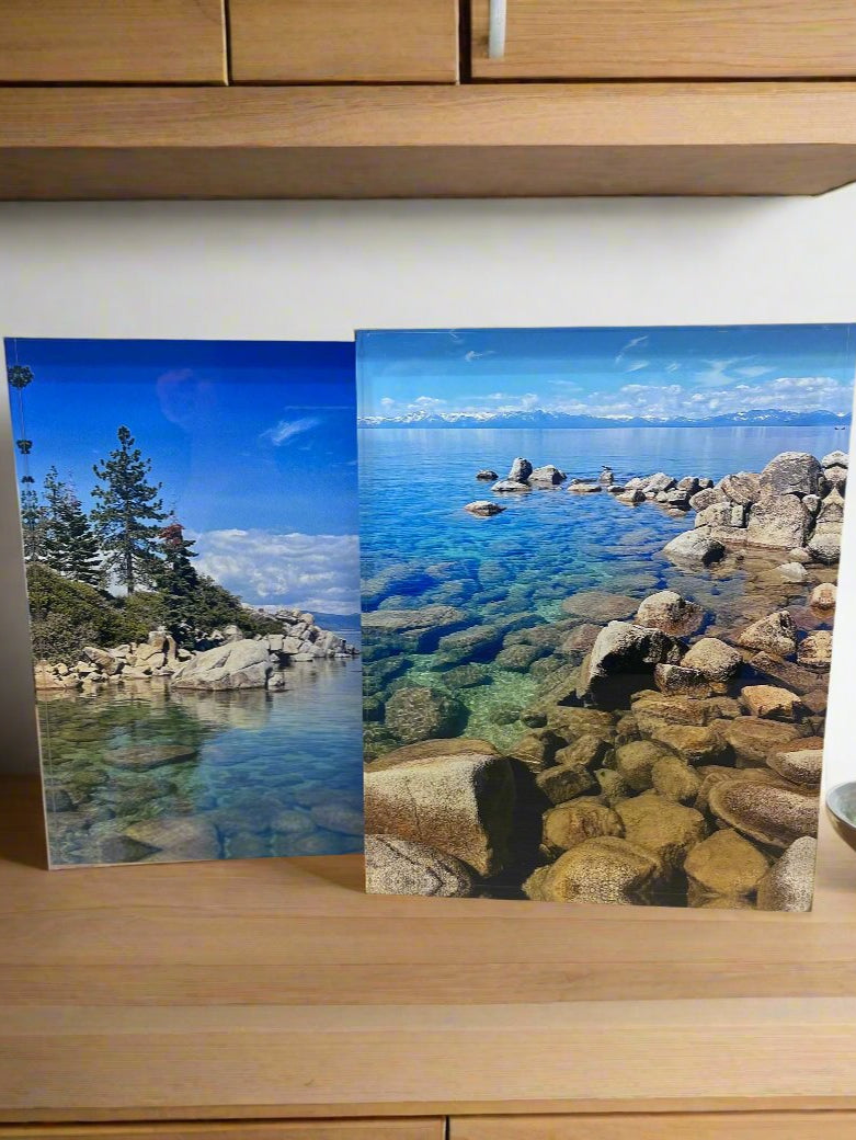 Clear acrylic photo display blocks with landscape prints, face-mount style on shelf