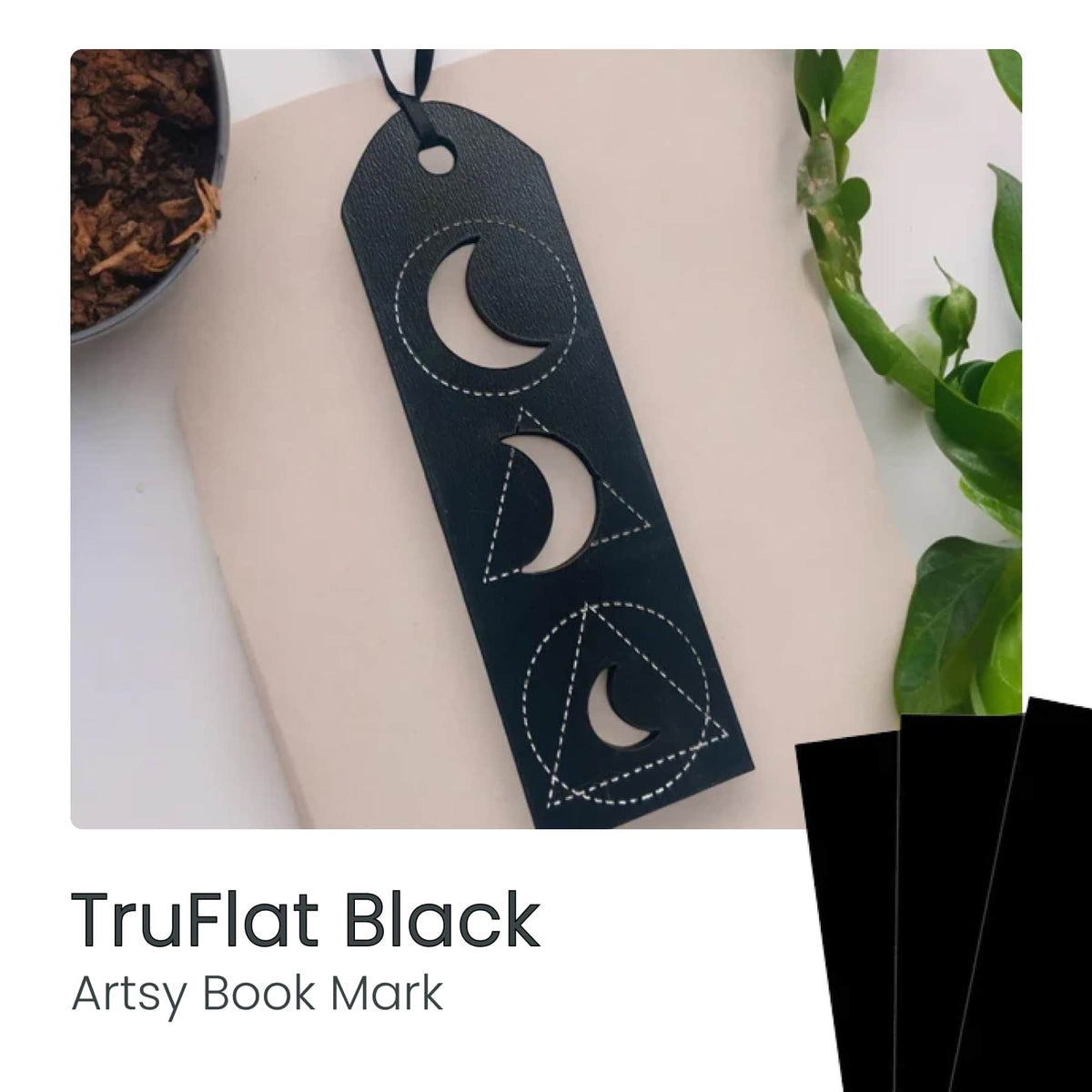 TruFlat laser-cut dark bookmark with stitched crescent moon pattern