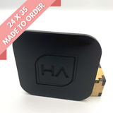 Glossy black acrylic sheet with etched HA logo, angled view of rounded square