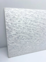 Pearl-finish white acrylic sheet, visible thickness edge, smooth rounded corner