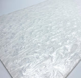 Pearl-finish white acrylic sheet close-up, swirled pearly marbling texture