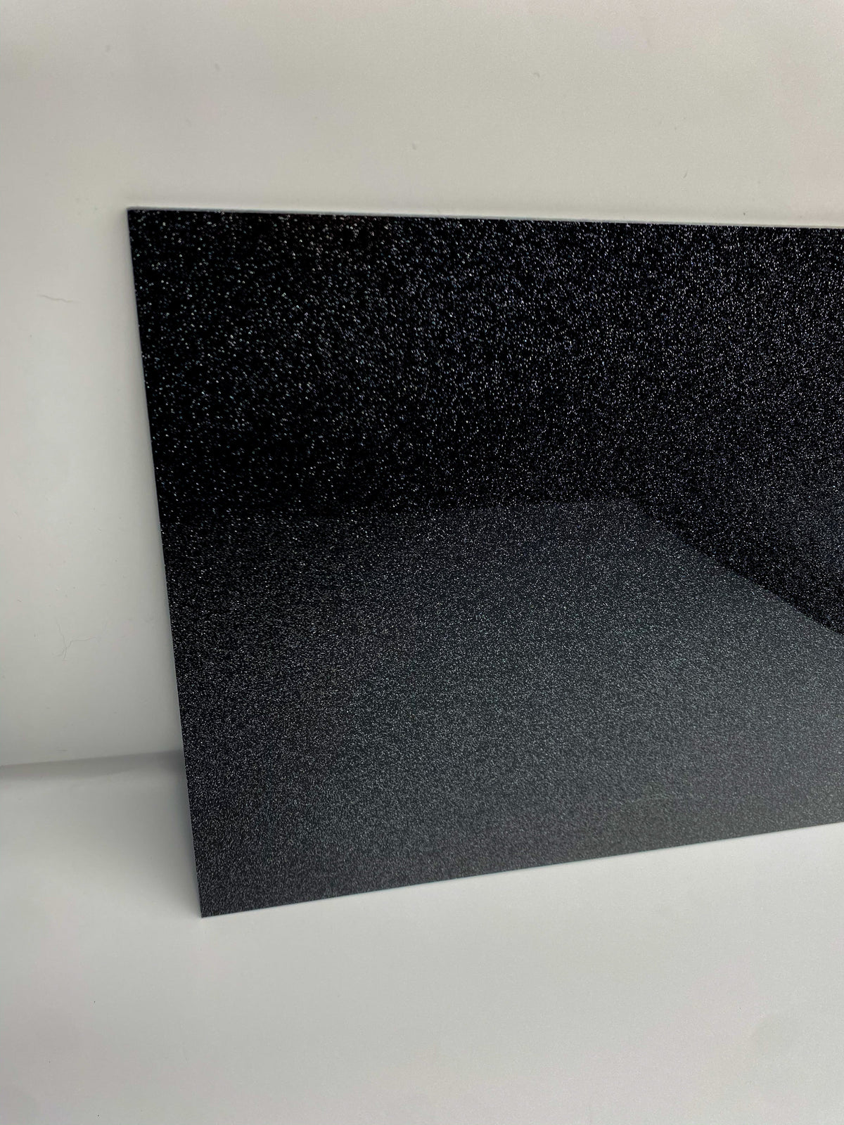 Black glitter acrylic sheet, rectangular panel with dark sparkling surface