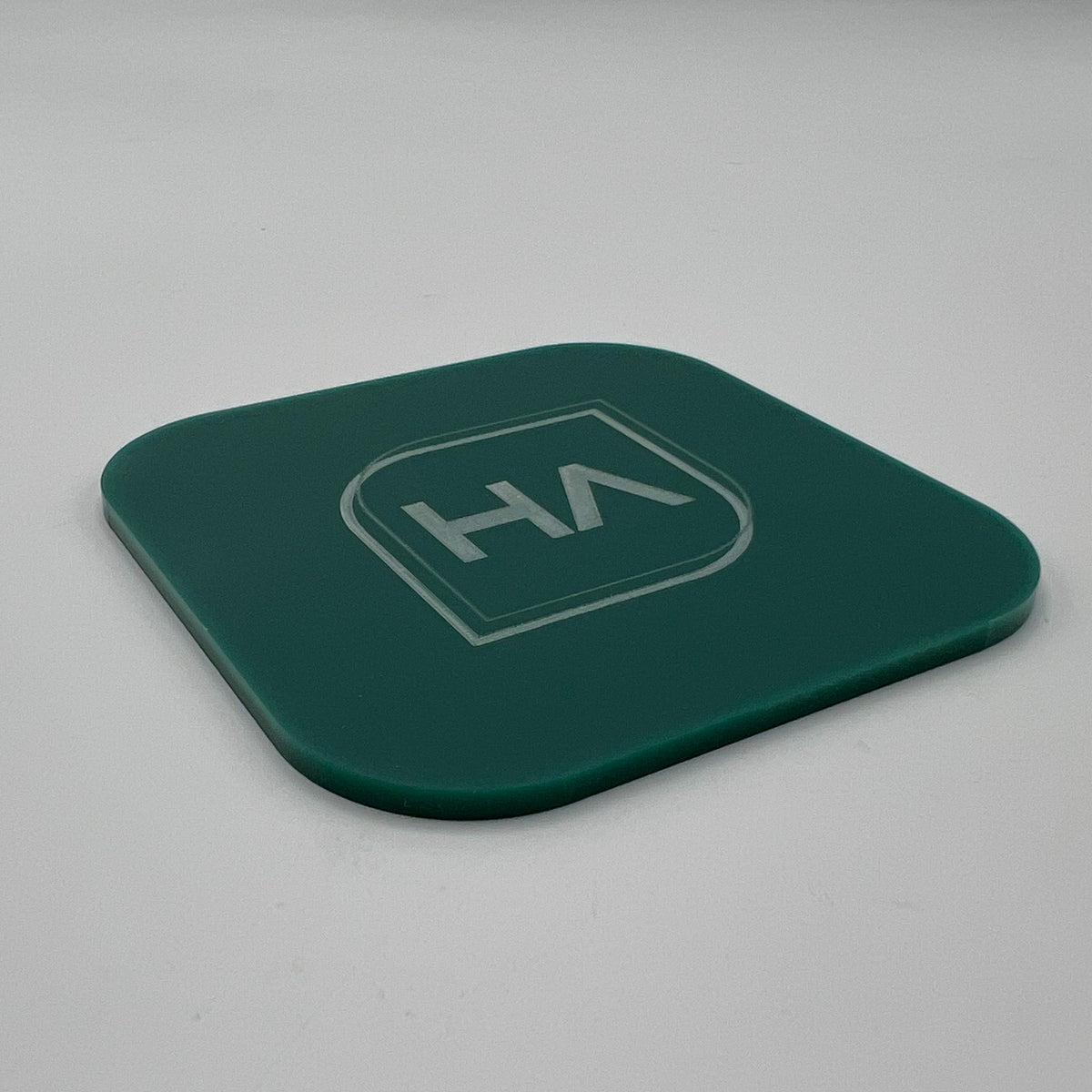 Matte evergreen cast acrylic sheet sample, dark green with HA logo center
