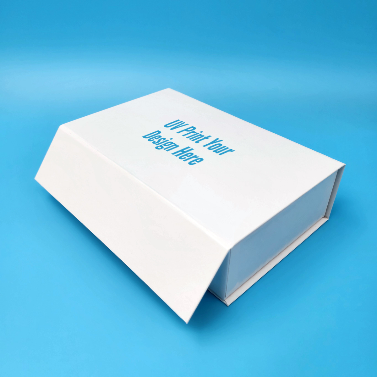 White rigid magnetic closure box with hinged lid, blue text print on top.